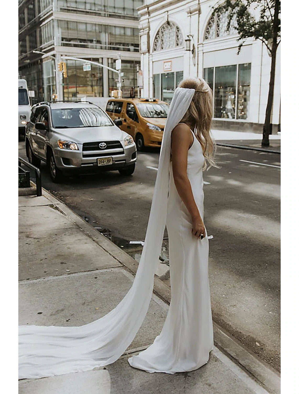 Side profile of a bride showcasing the long bridal veil.