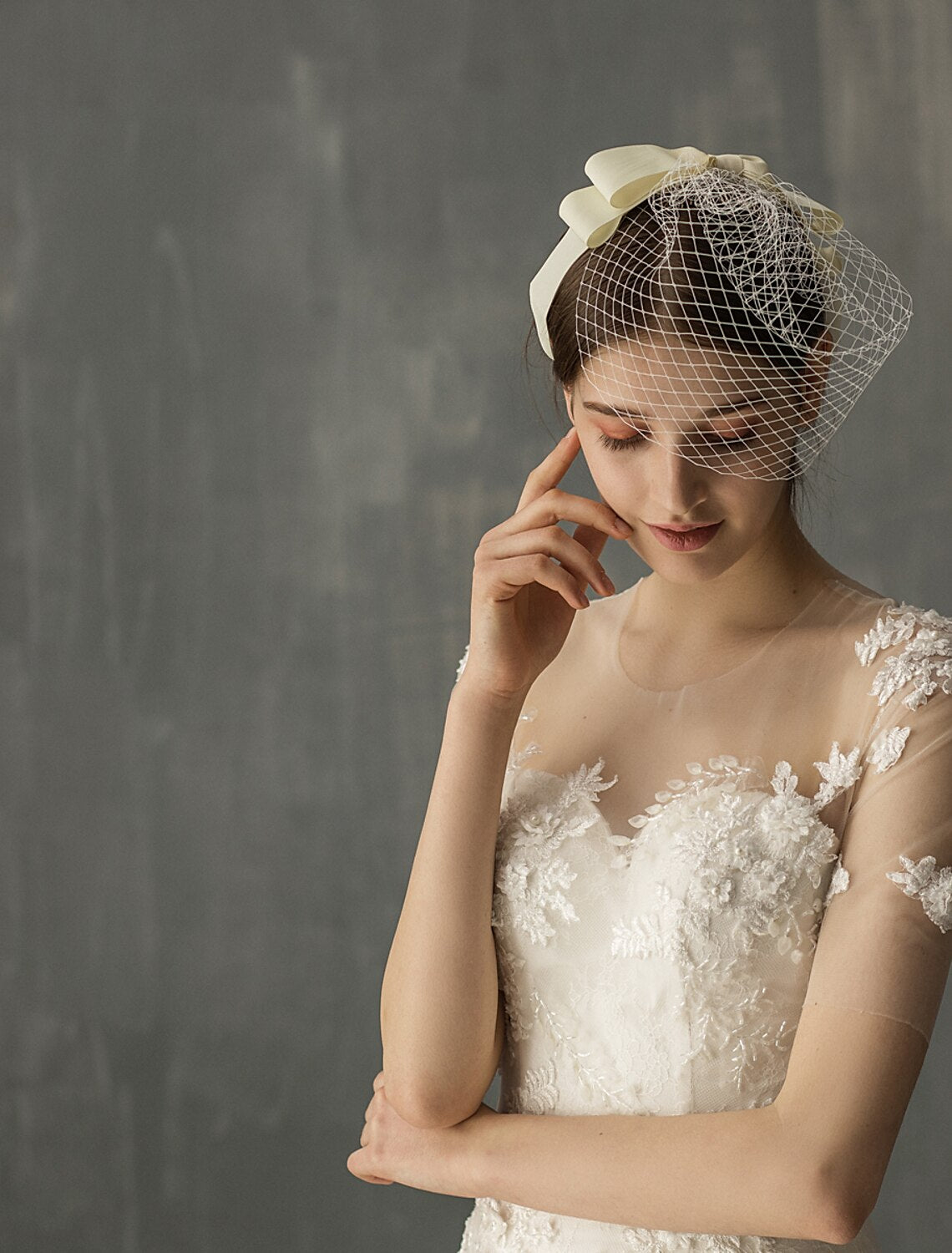 Close-up of the ribbon bow detail on a stylish wedding blusher veil.