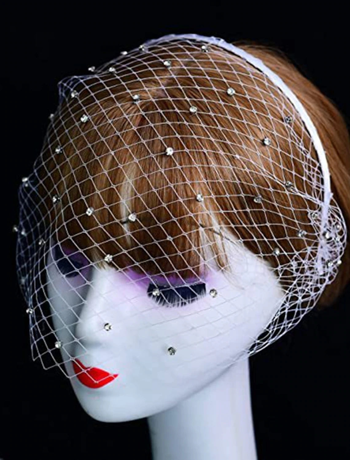 Elegant one-tier wedding veil with sparkling crystals and rhinestones, draped gracefully.