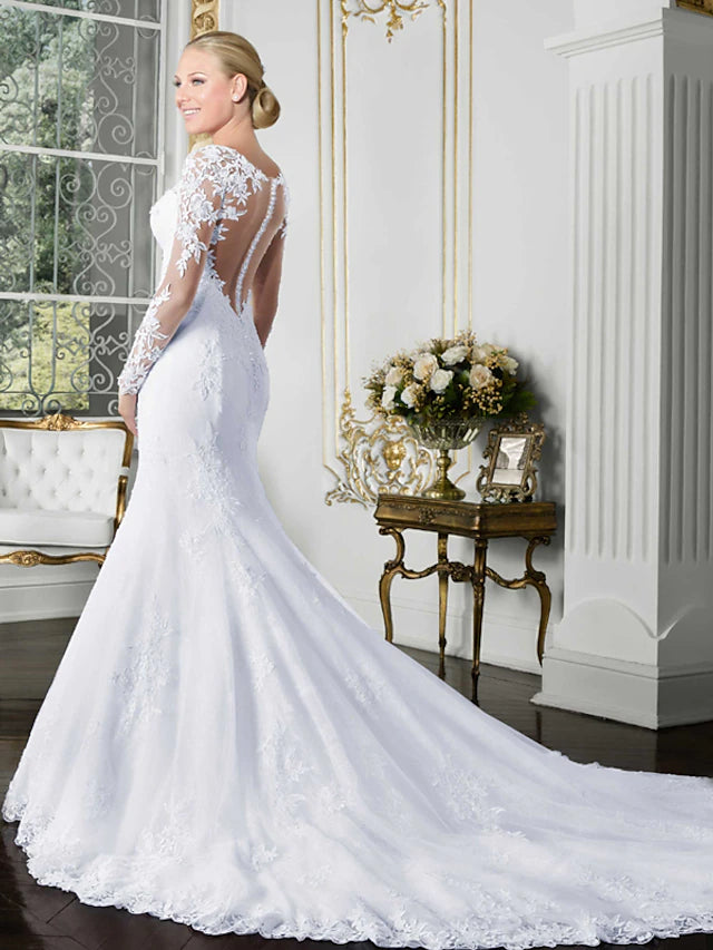 Back view of the wedding dress showing open back and chapel train.