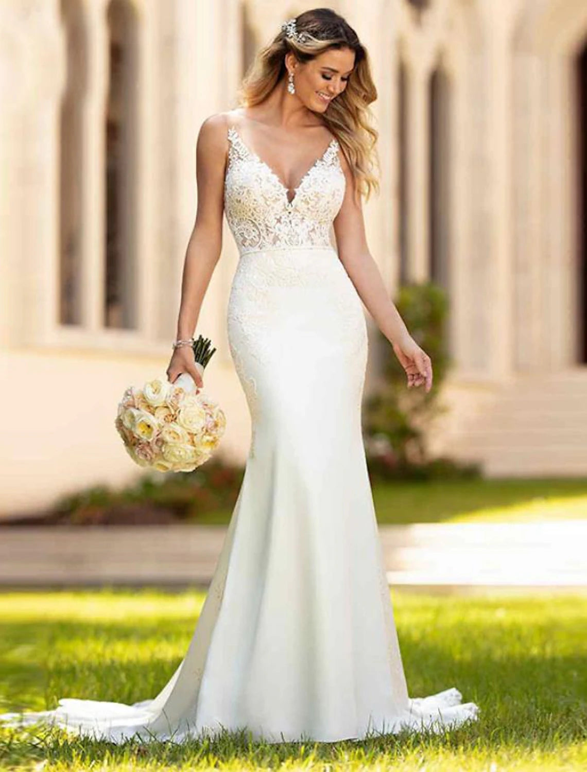 Elegant mermaid wedding dress with V-neckline and lace appliques.
