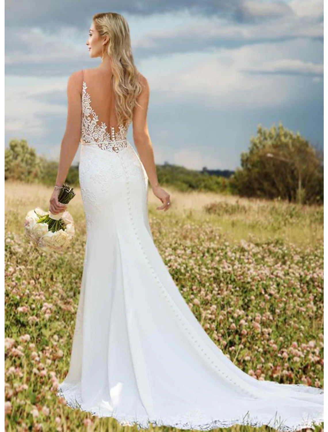 Close-up of intricate lace appliques on the V-neck wedding dress.