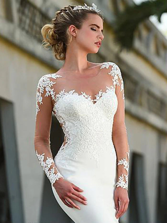 Formal crepe wedding gown featuring an illusion neckline and court train.