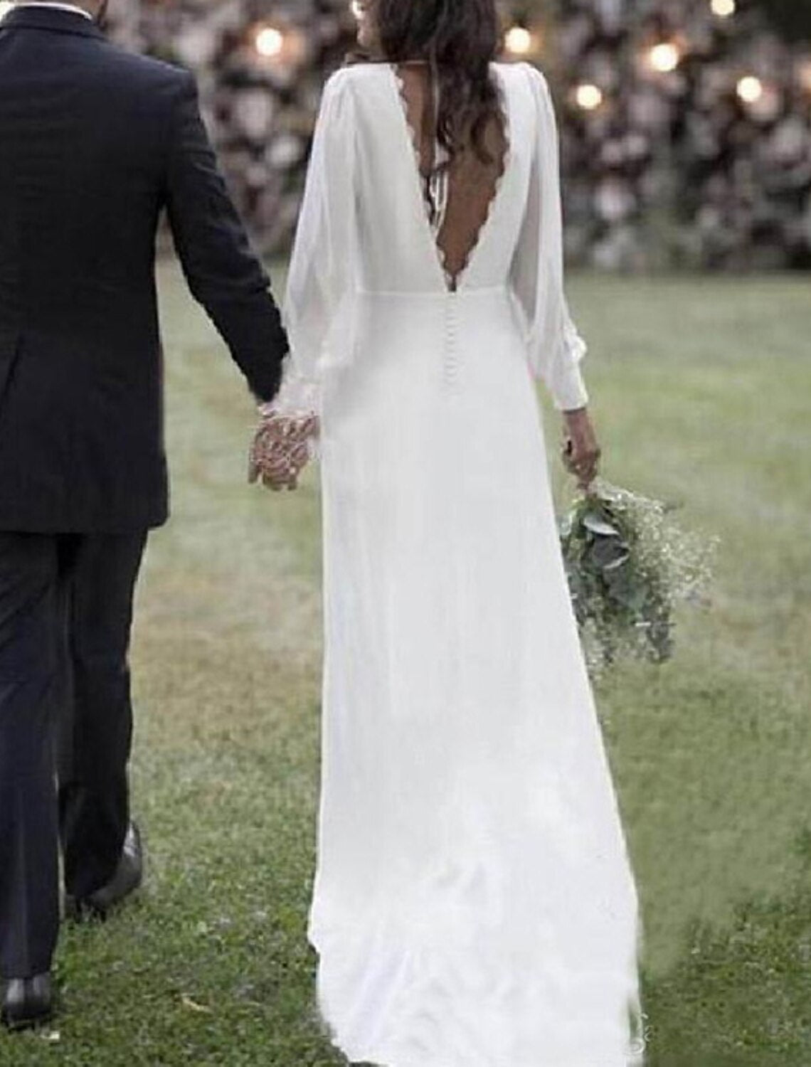Close-up view of the open back and V-neckline of the chiffon wedding dress.