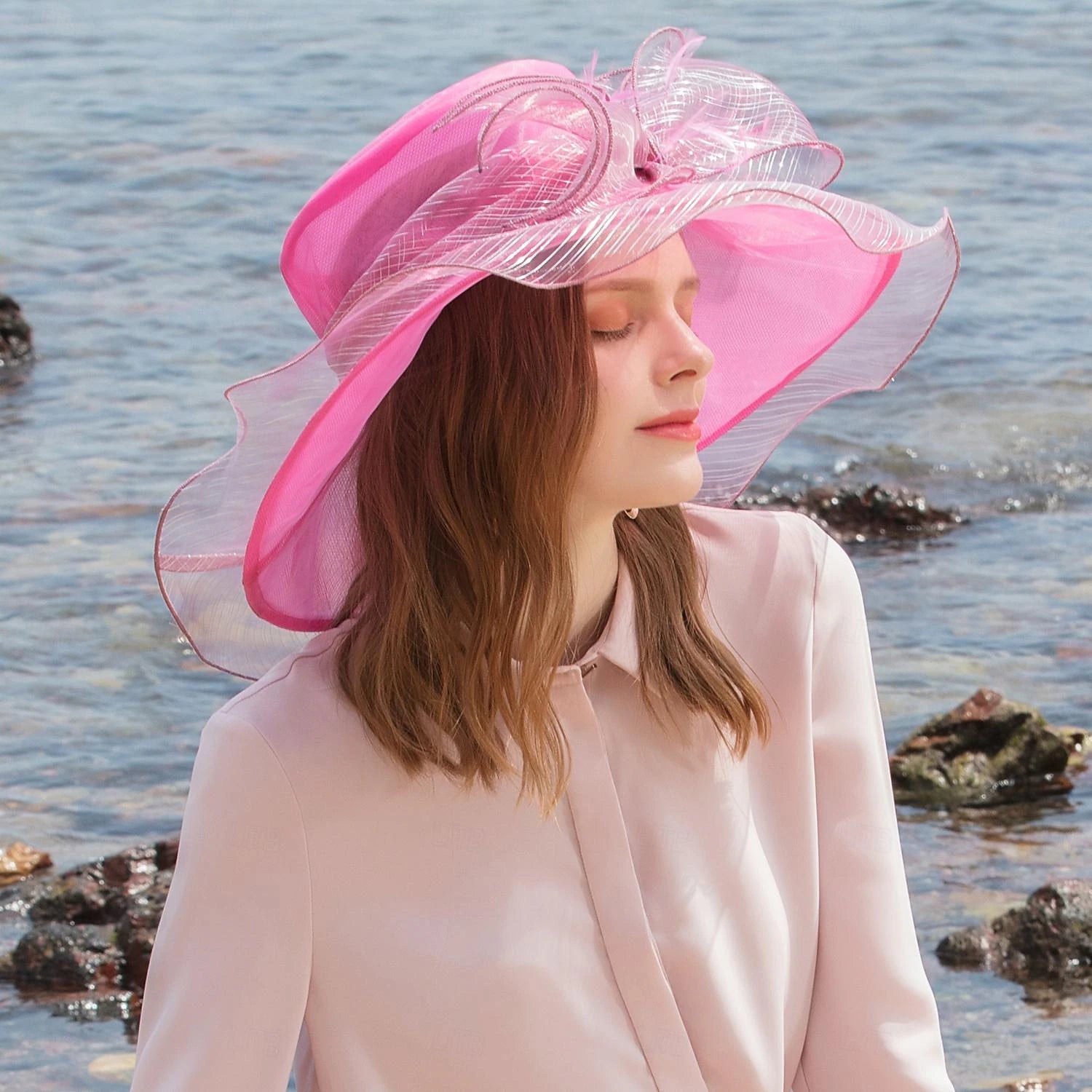 Elegant organza fascinator hat with feather and bowknot.