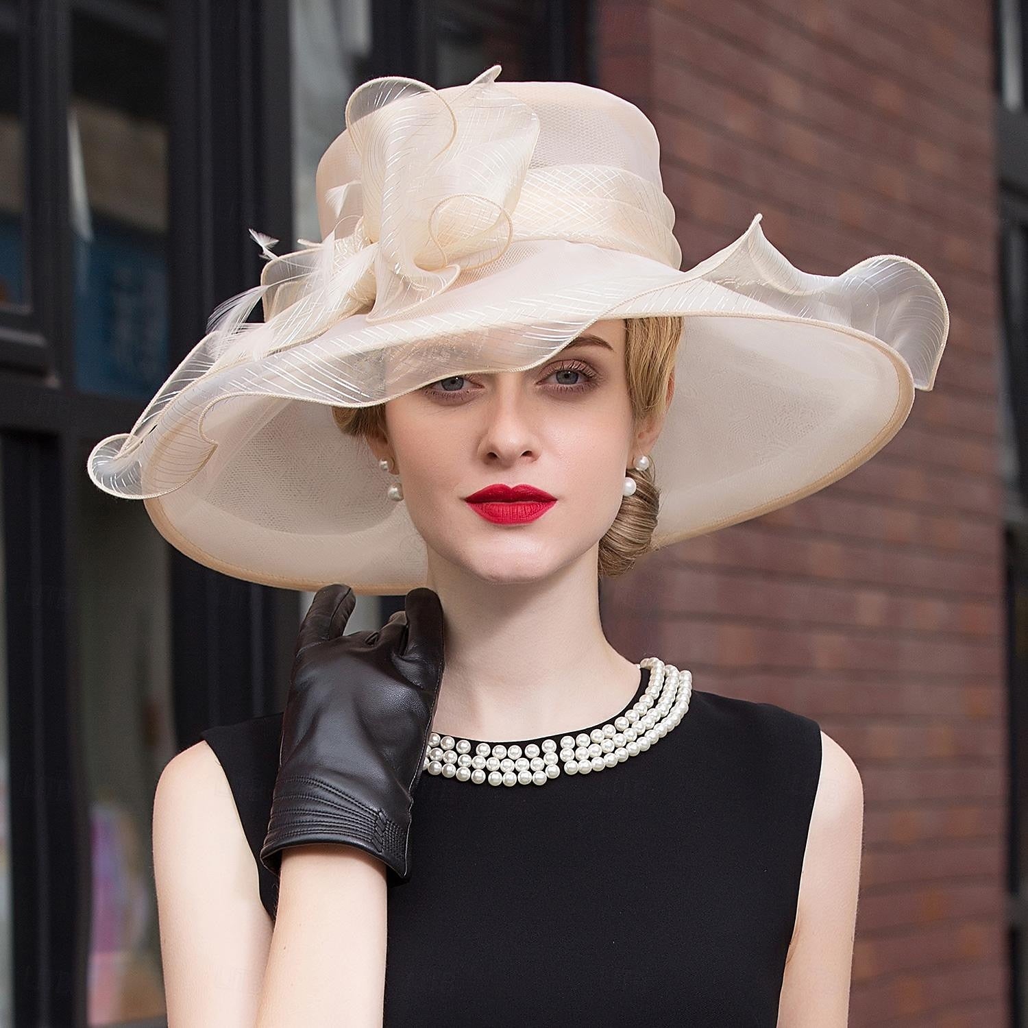 Woman wearing a stylish organza tea party hat.