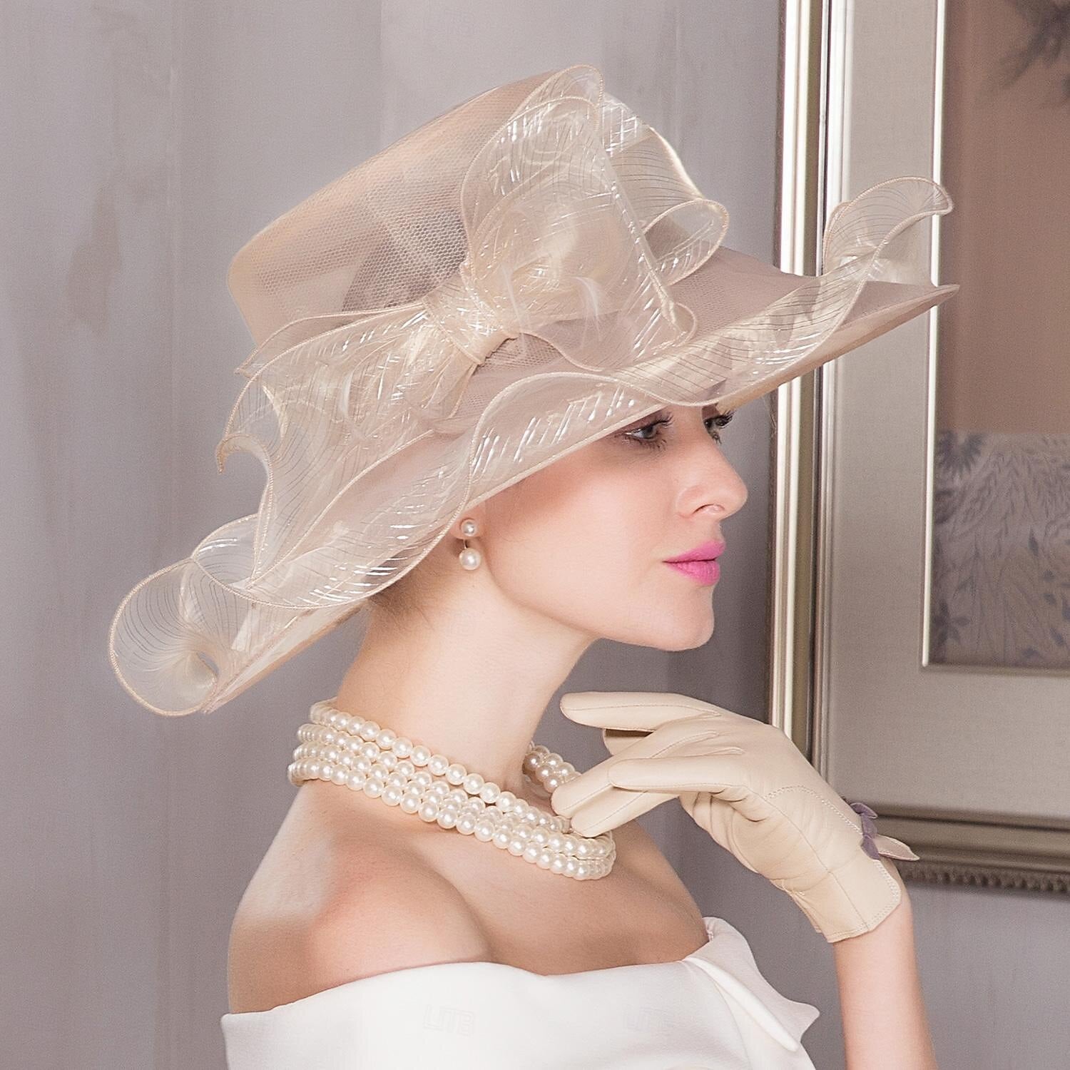 Organza sun hat with a wide brim and decorative elements.
