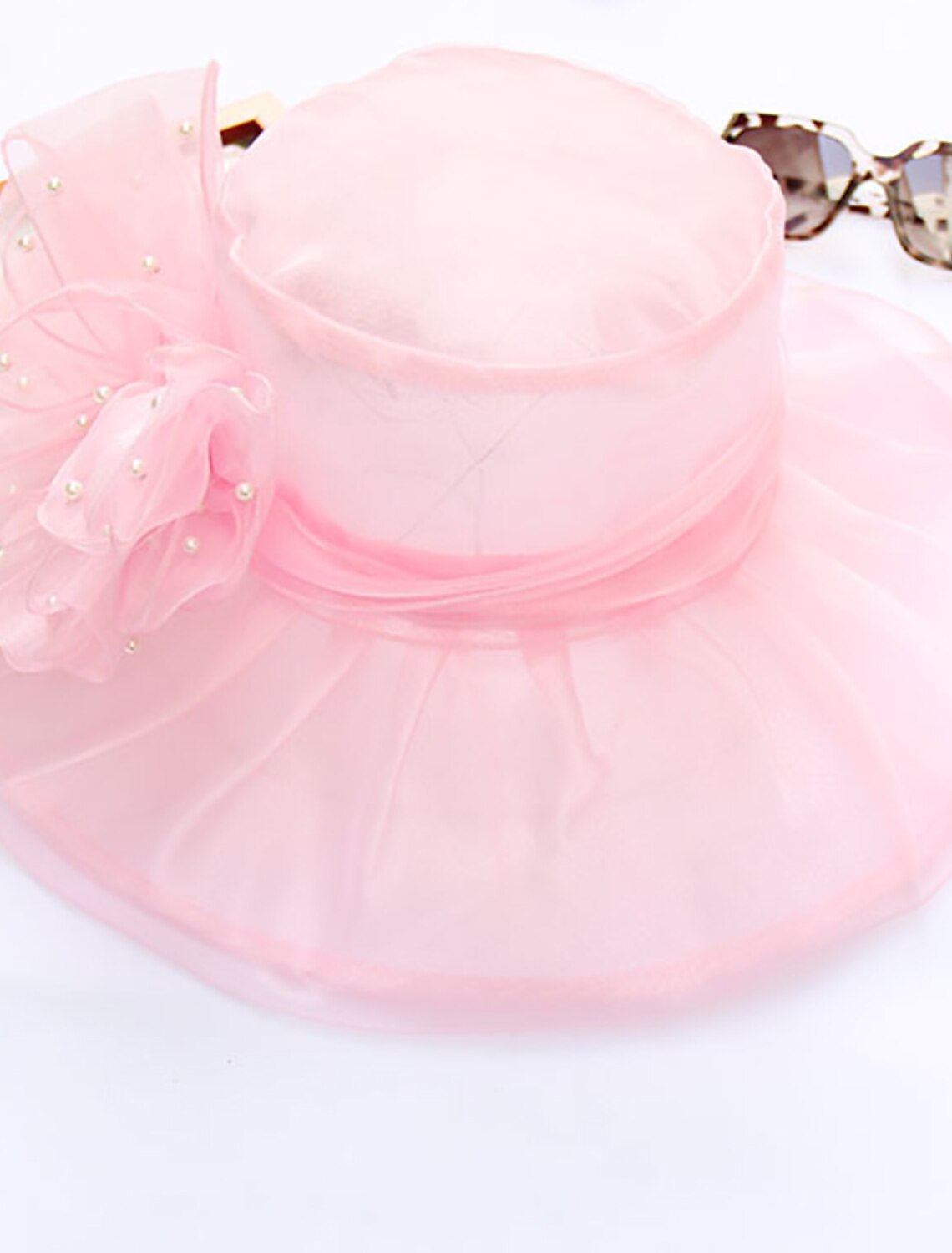 Side view of the organza Kentucky Derby hat with faux pearl details.