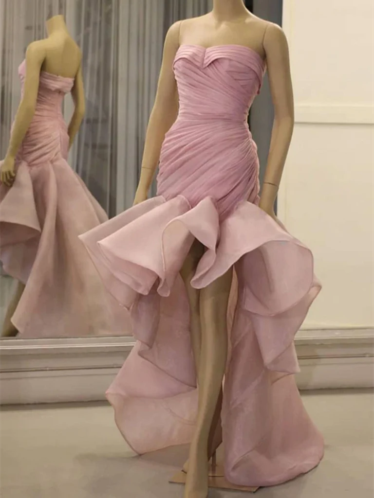 Woman wearing an elegant mermaid organza high-low sweetheart prom dress.