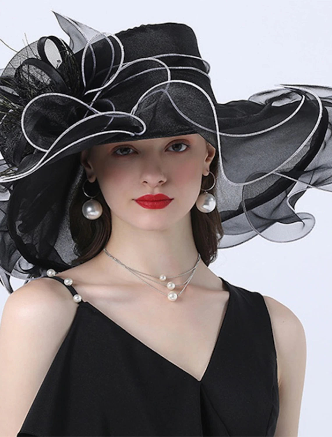 Elegant organza tulle hat with a large bowknot and flower trim.