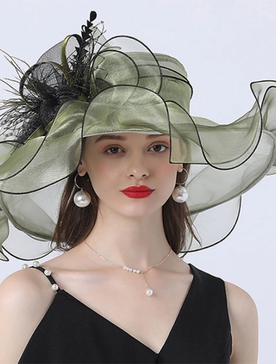 Woman wearing a sophisticated vintage-style organza hat.