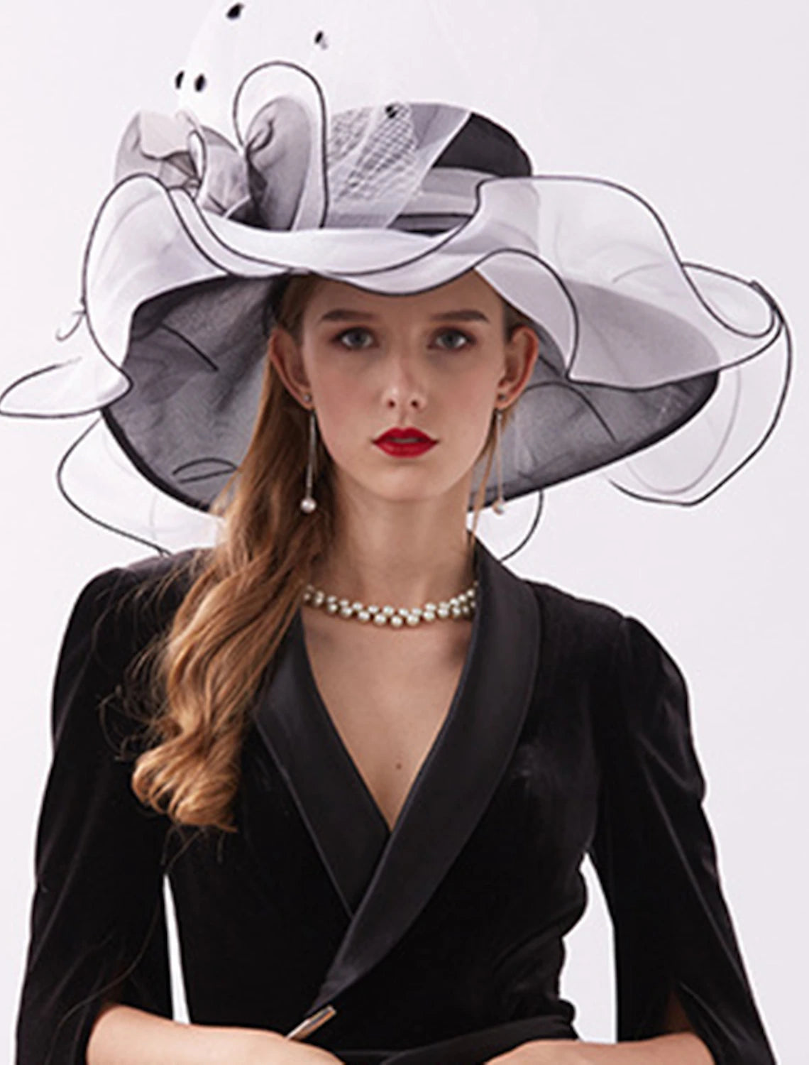 Woman wearing an elegant organza wide brim derby hat.