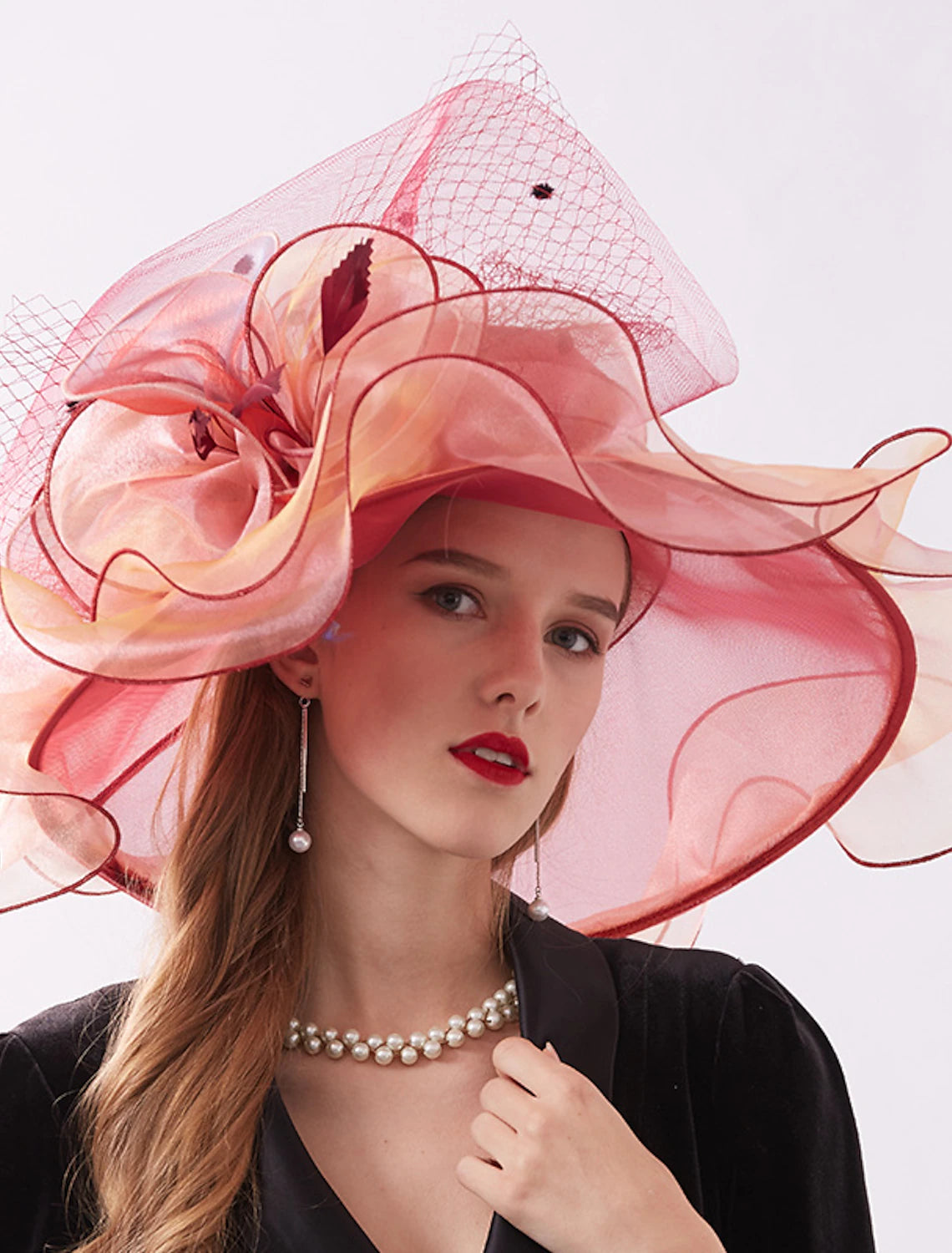 Woman posing with the sophisticated organza fascinator hat.