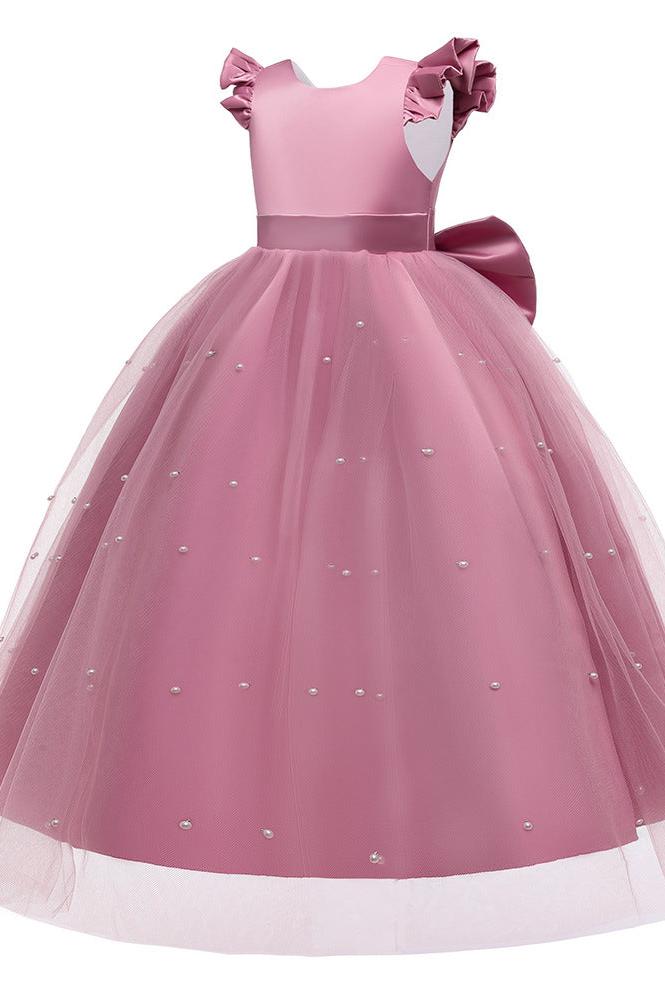 Side view of a girl in a white flower girl dress with a flowing cape.