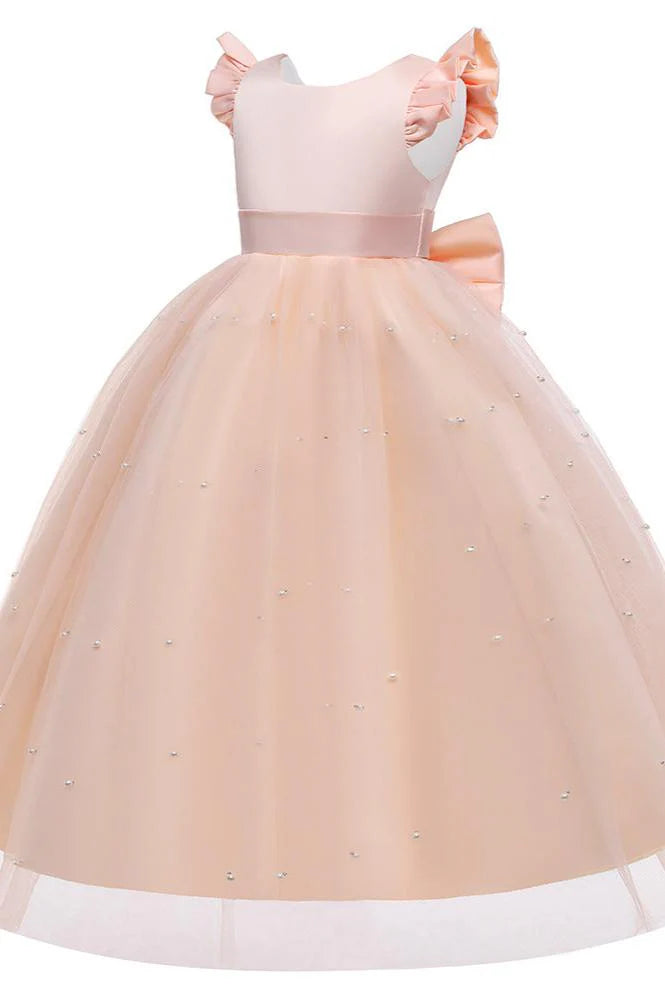 Girl in a white flower girl dress with a pearl-embellished cape.