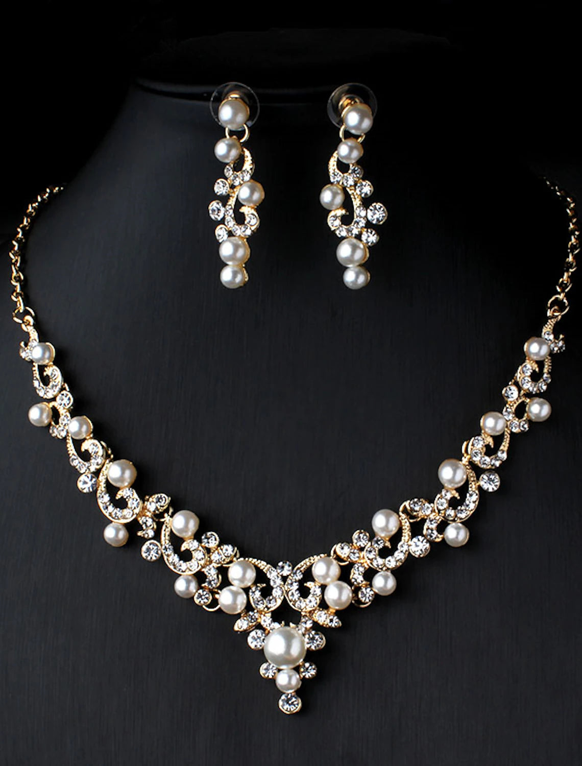 Woman wearing an elegant pearl and rhinestone floral necklace and matching earrings.