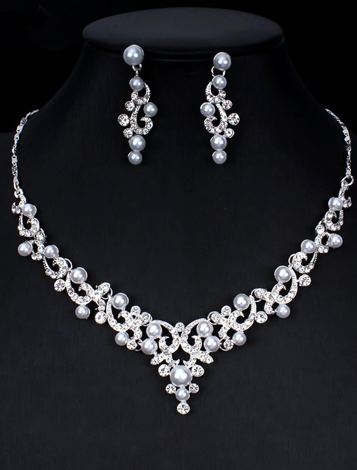 Close-up of a pearl and rhinestone floral necklace.
