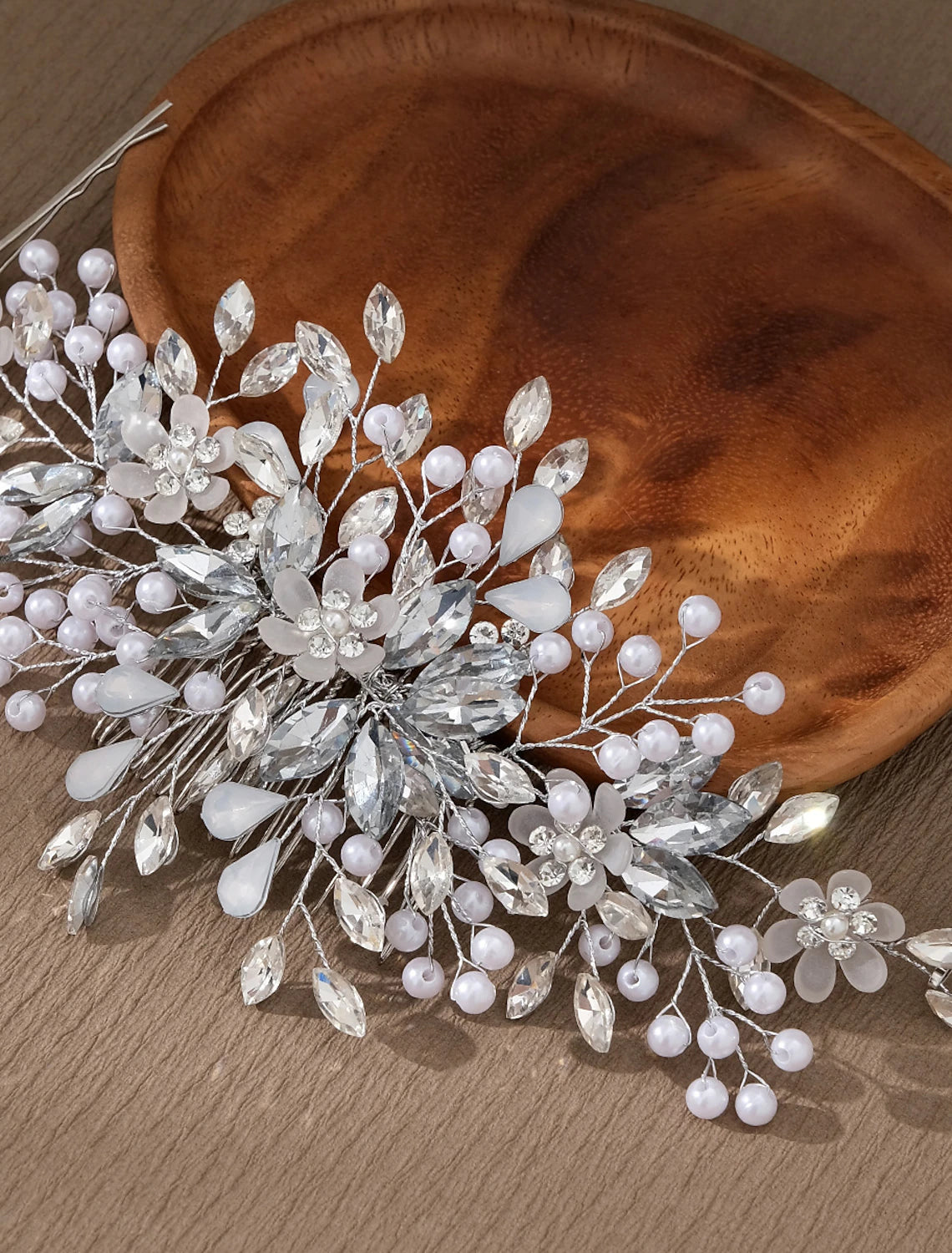 Elegant wedding headpiece comb featuring imitation pearls and sparkling rhinestones, styled in hair.