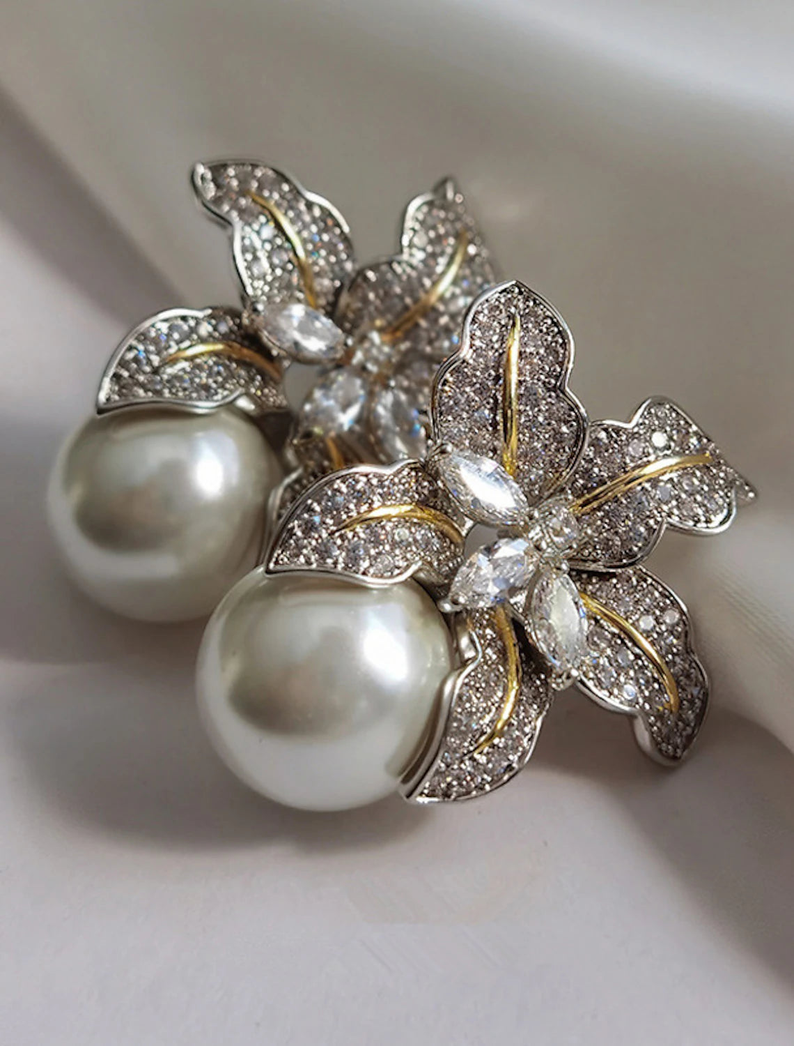Close-up of a gold petal stud earring.