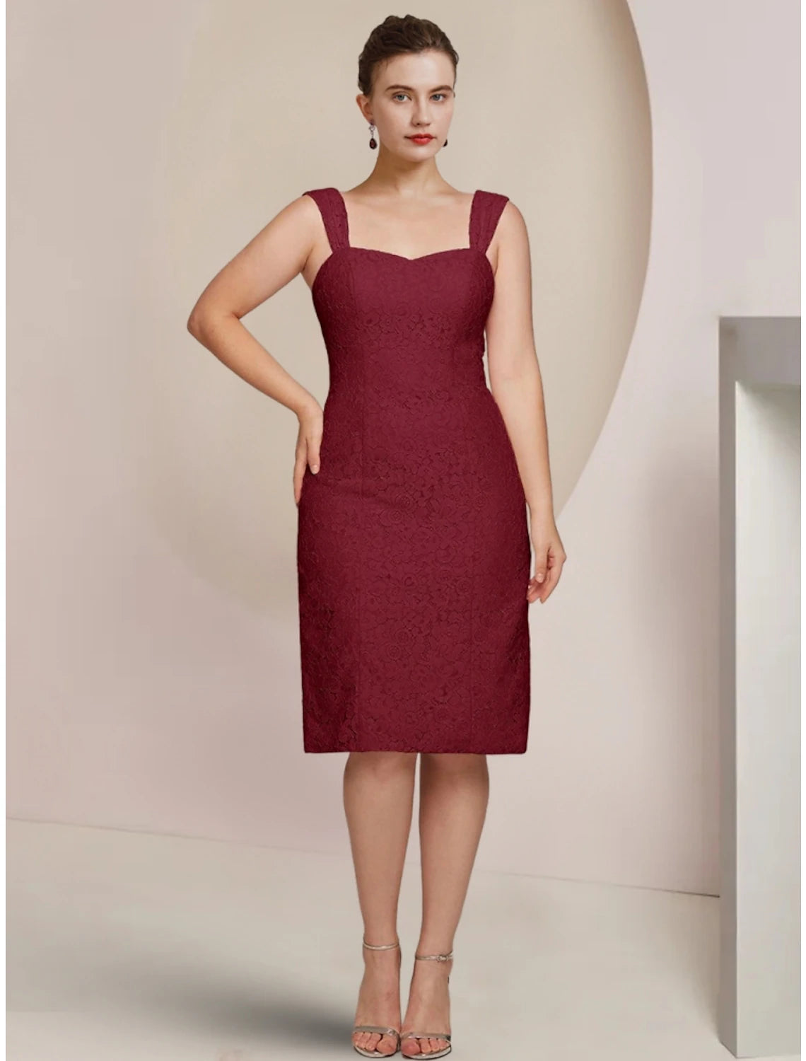Side view of a knee-length chiffon dress, featuring delicate ruching.
