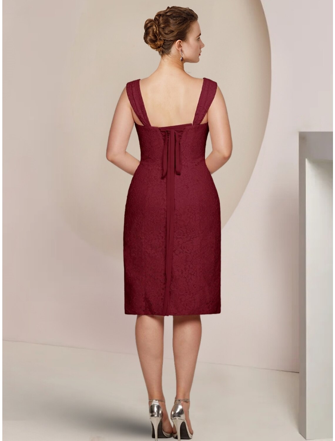 Back view of a solid color formal gown, suitable for wedding guests.