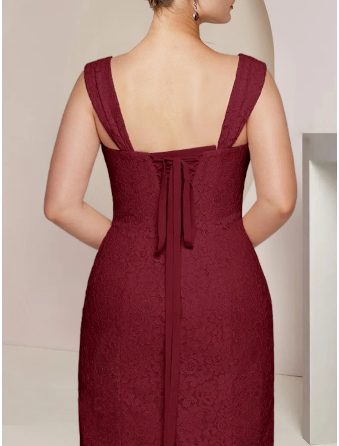 Full length view of the elegant knee-length dress, highlighting its silhouette.