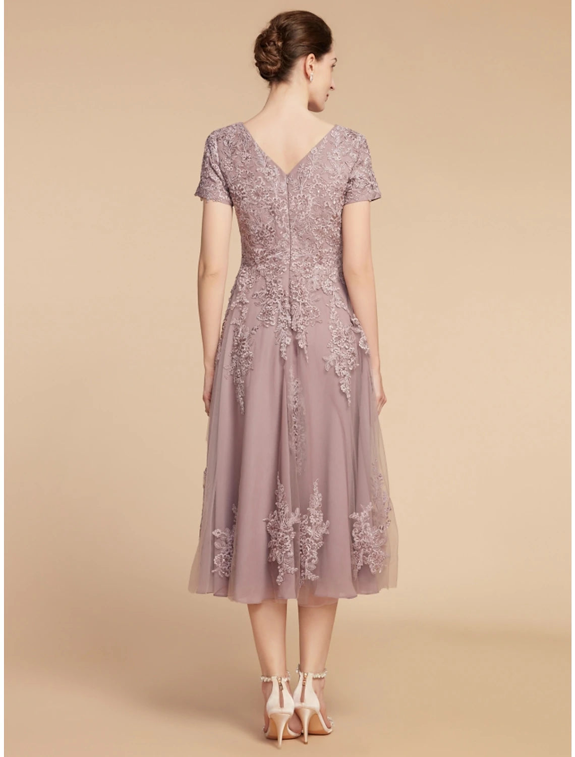 Back view of the A-line lace and tulle dress with ruching.