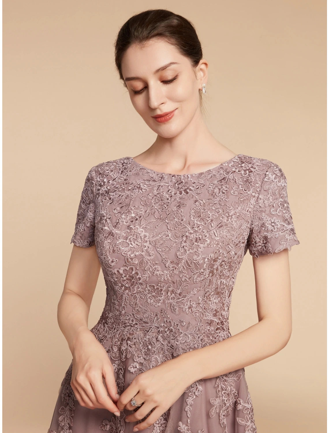 Close-up of the lace and floral detail on the short sleeve dress.