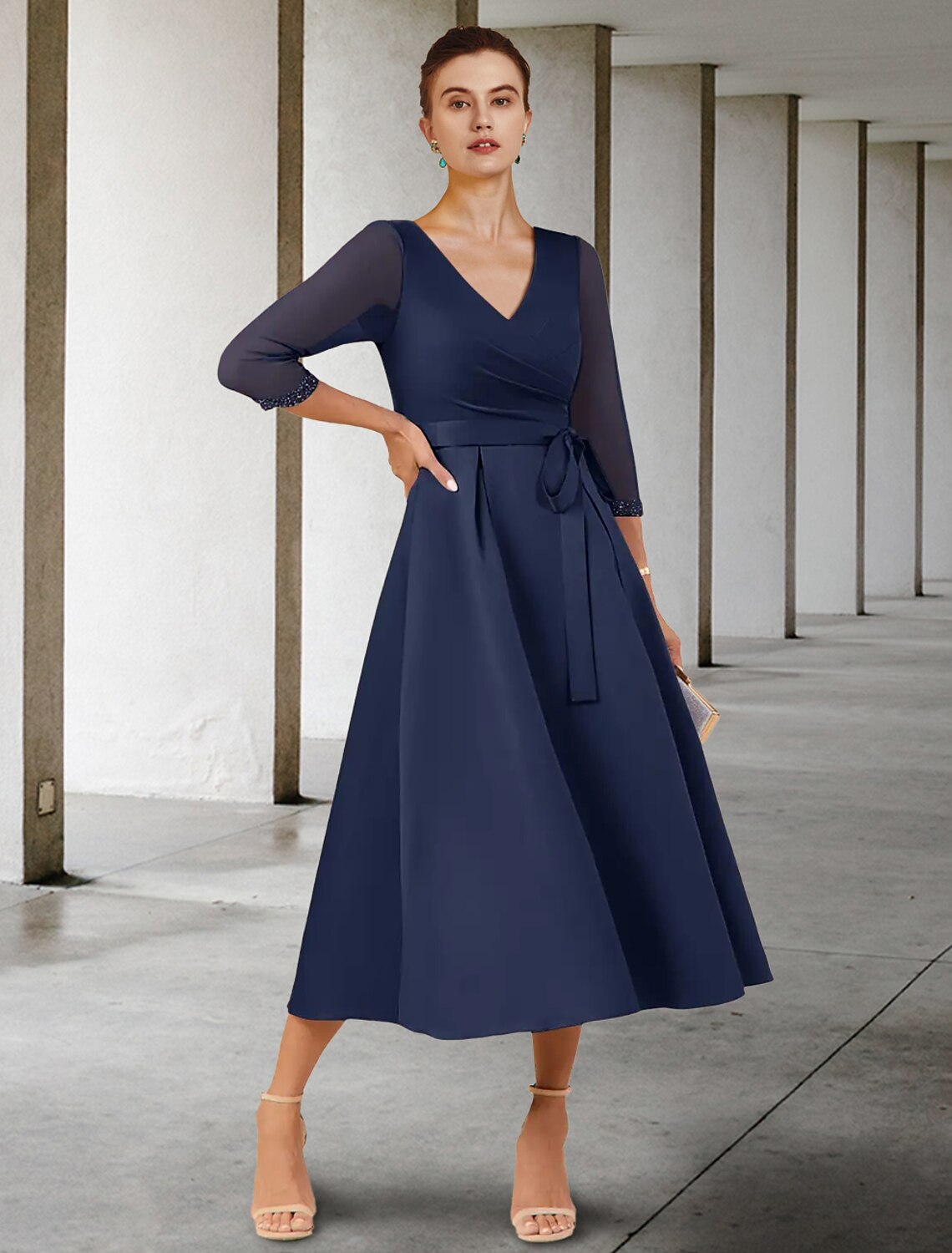 Elegant petite A-line V-neck tea length dress with 3/4 sleeves and ruching.