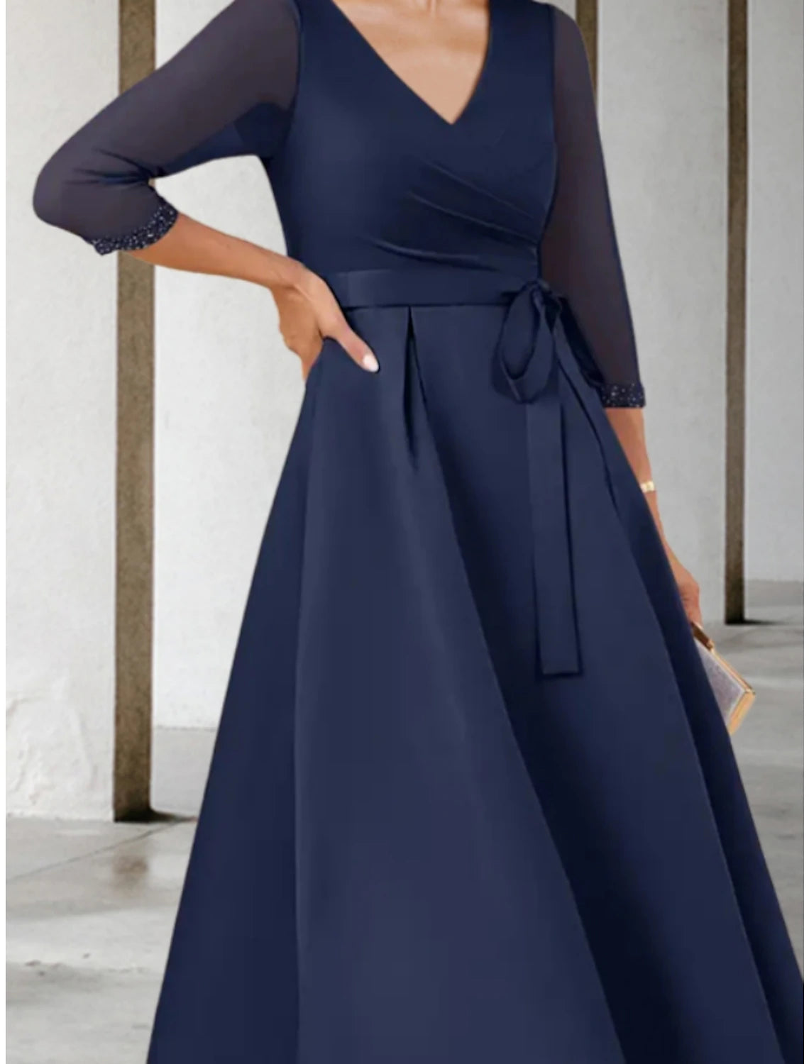 Petite mother of the bride dress featuring a V-neck and bow detail.
