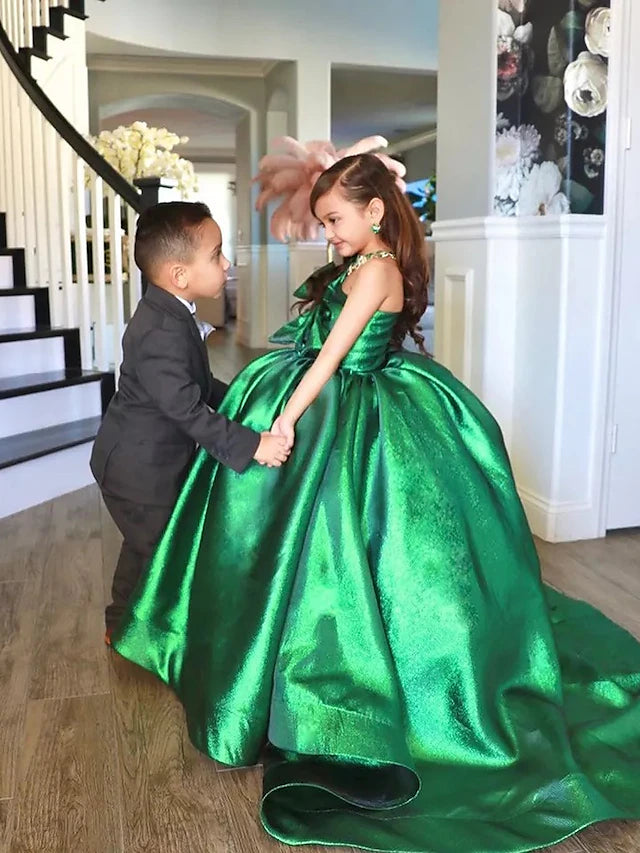 Back view of an elegant pink ball gown flower girl dress, highlighting the bows and sweep train.