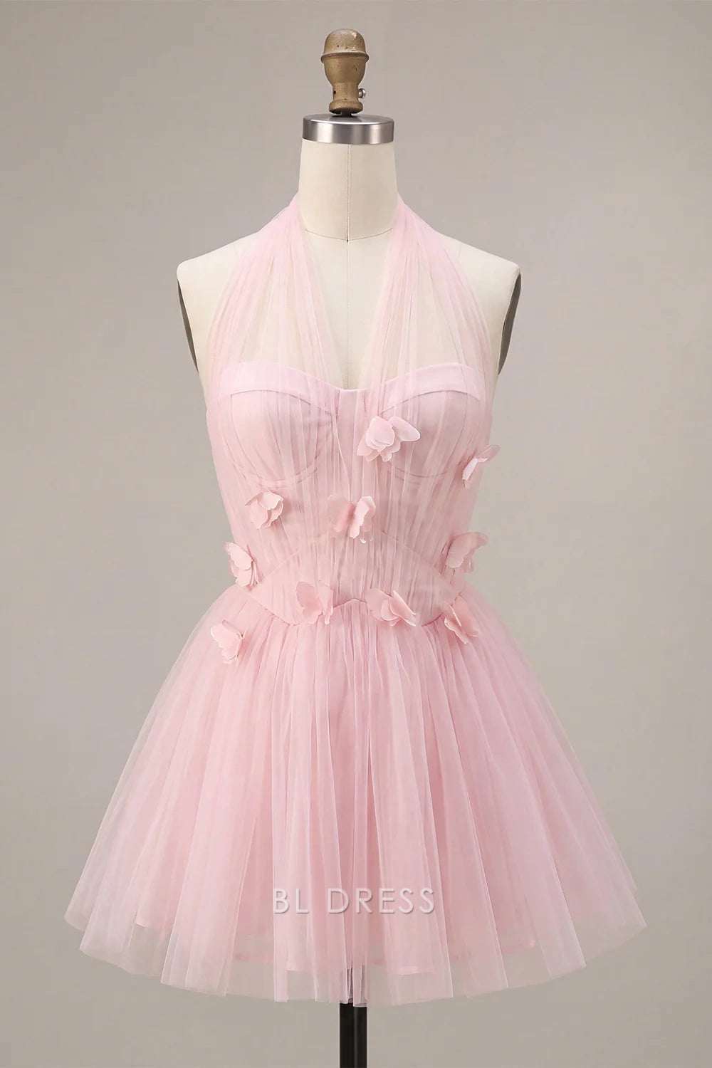Detailed close-up of 3D floral butterfly appliques on the pink dress bodice.