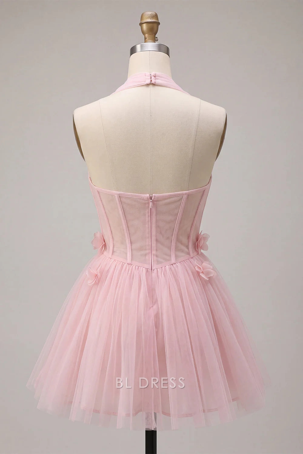 Model posing in a short pink tulle A-line party dress.