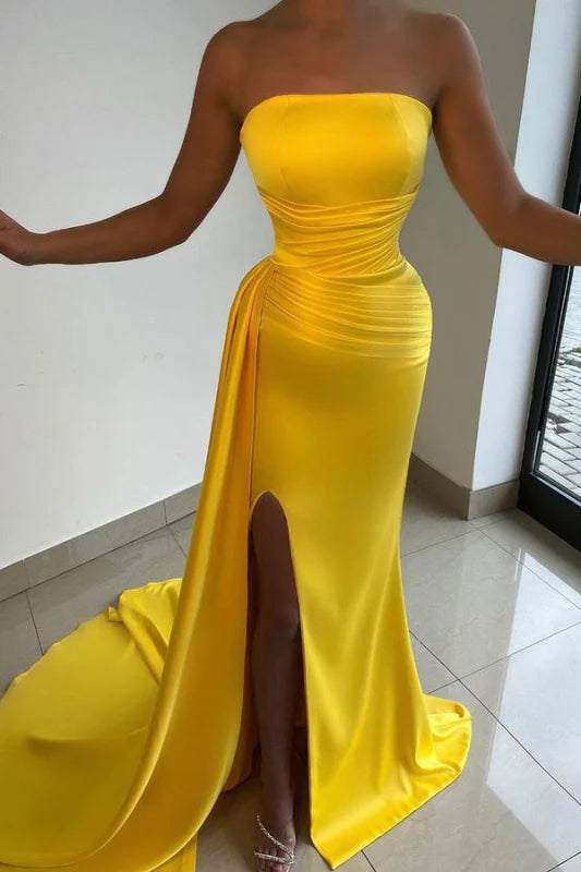 Elegant strapless pleated maxi dress with a split hem, suitable for prom.