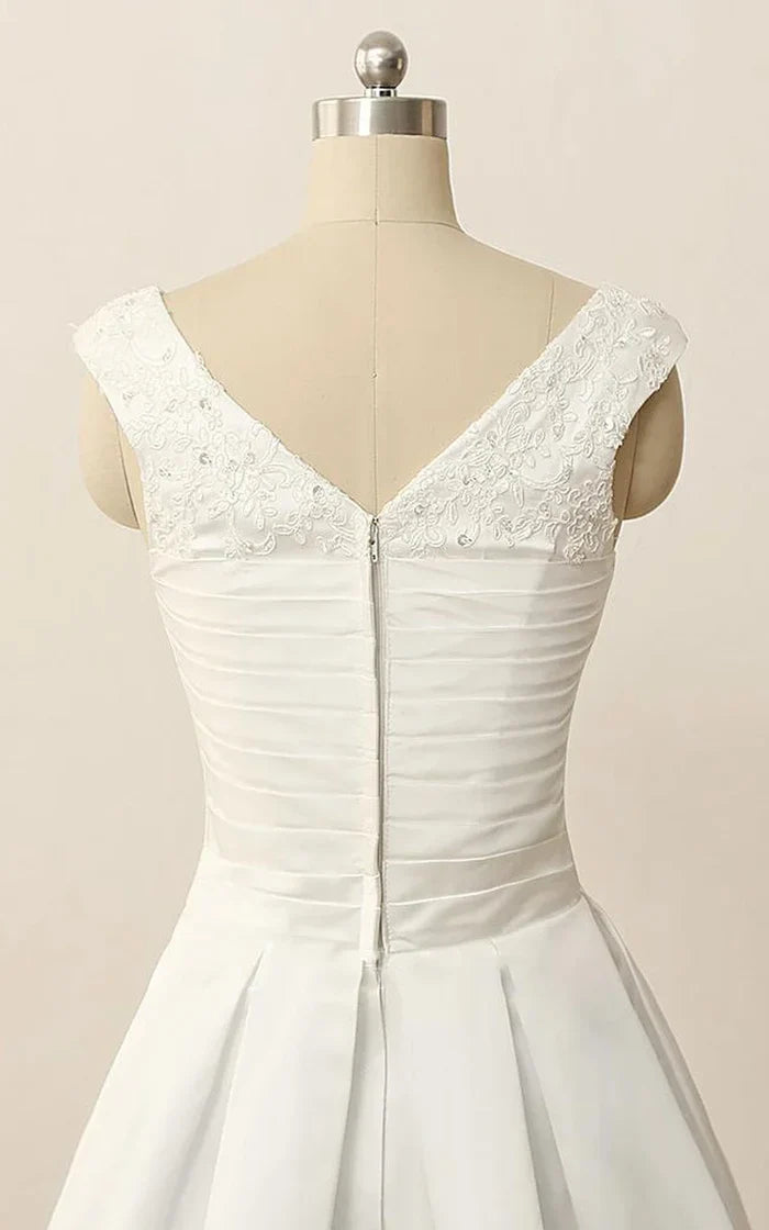 Close-up of the V-neckline and delicate beading on the satin dress.