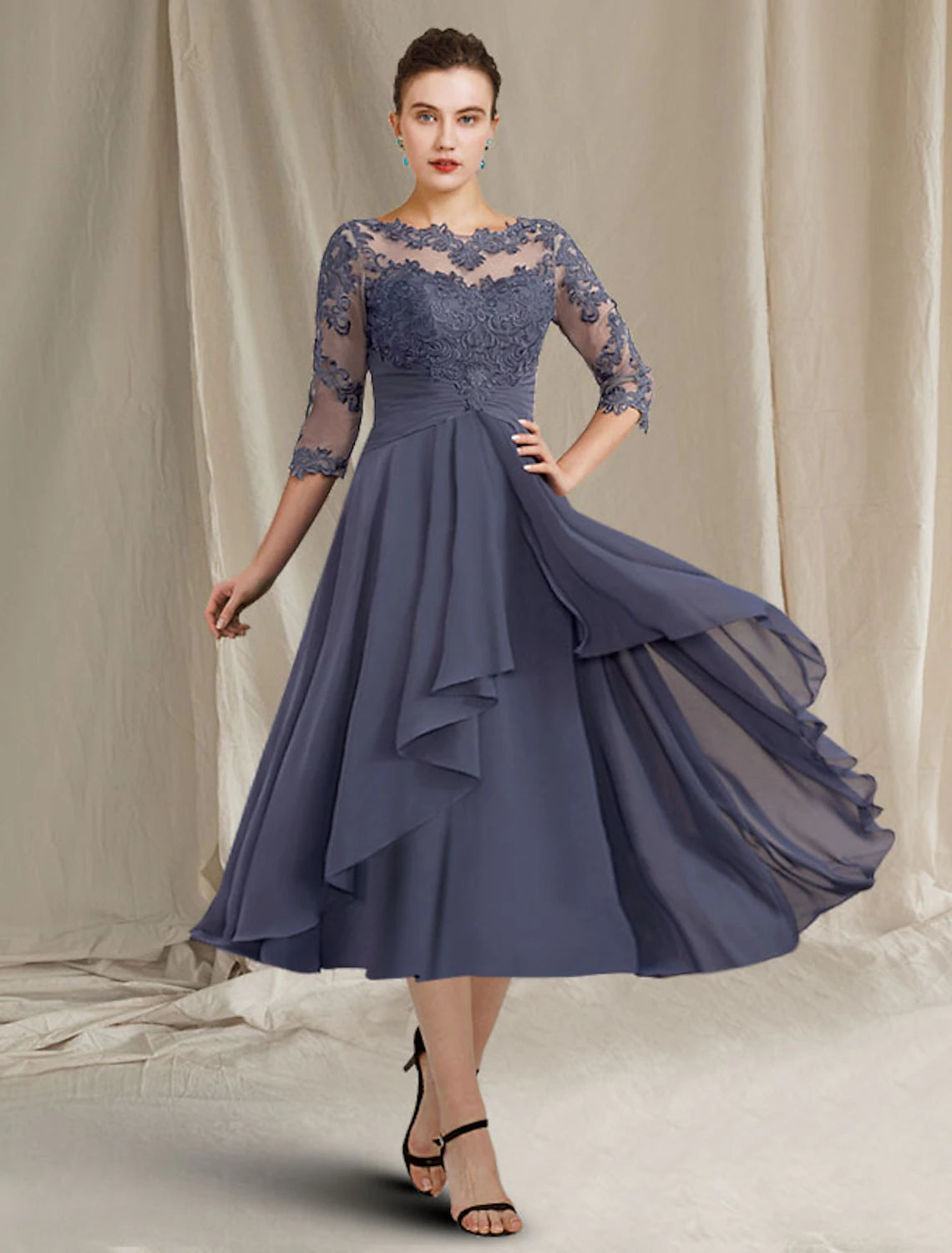 Plus size woman wearing an elegant A-line mother of the bride dress with jewel neck and 3/4 sleeves.