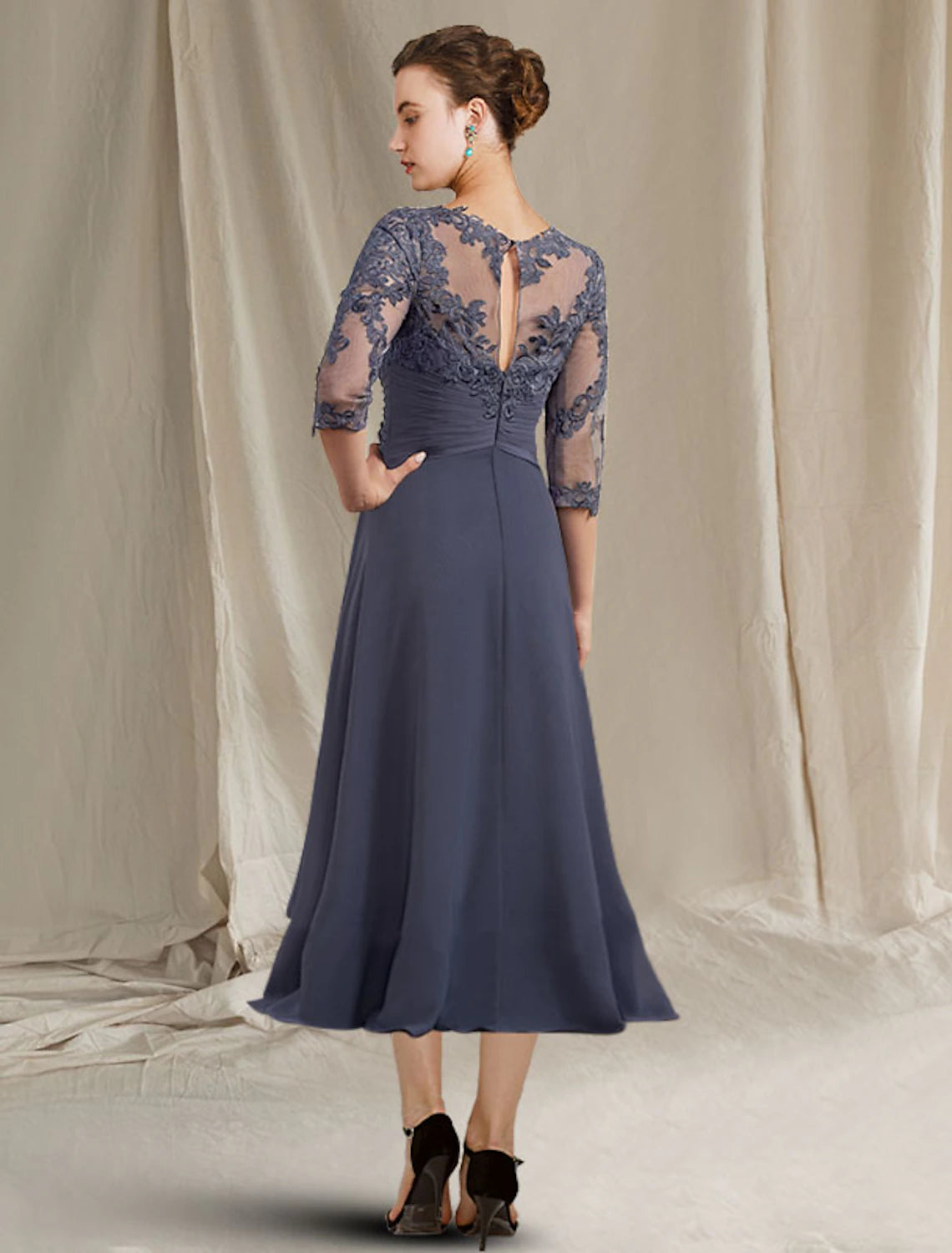 Back view of the plus size A-line chiffon lace tea length dress, showing pleats and appliques.