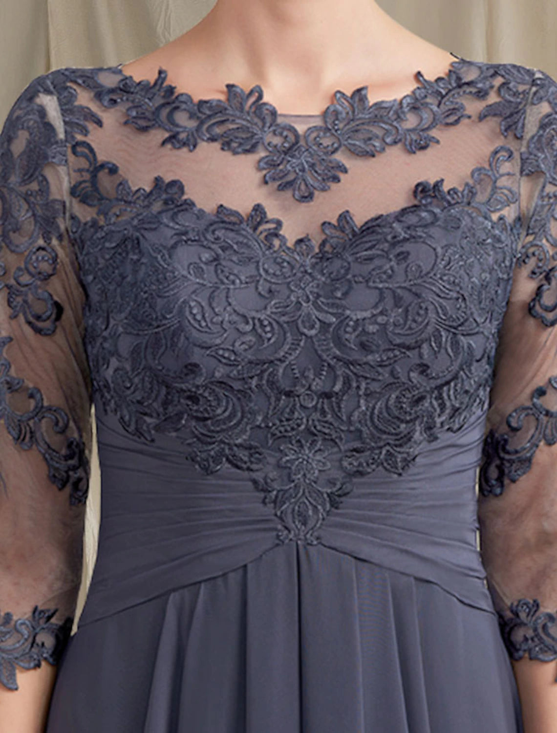 Close-up of the chiffon lace fabric and applique details on the elegant mother of the bride dress.
