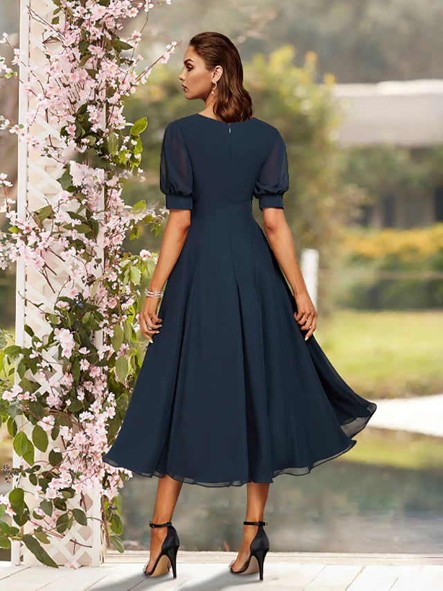 Back view of the pleated tea length mother of the bride dress.