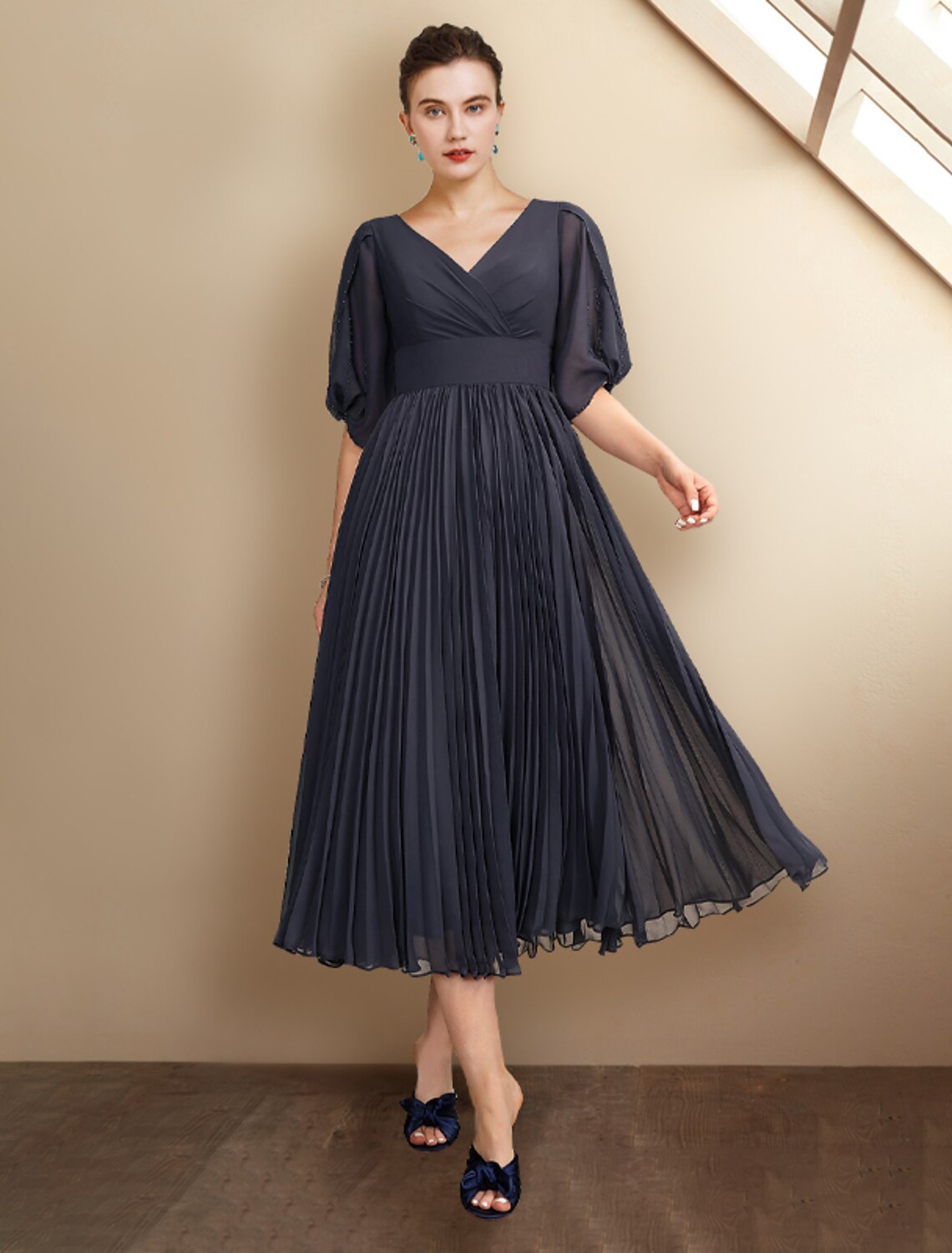 Elegant plus size A-line Mother of the Bride dress with V-neck and half sleeves.