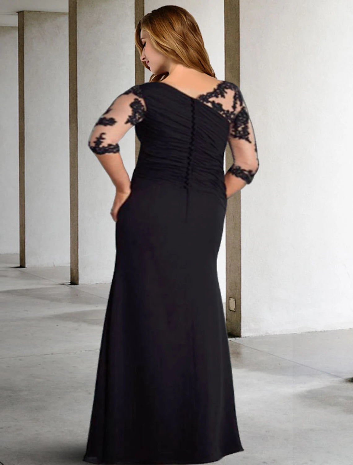Back view of an elegant A-Line plus size formal dress, showing floor length chiffon fabric and delicate detailing.