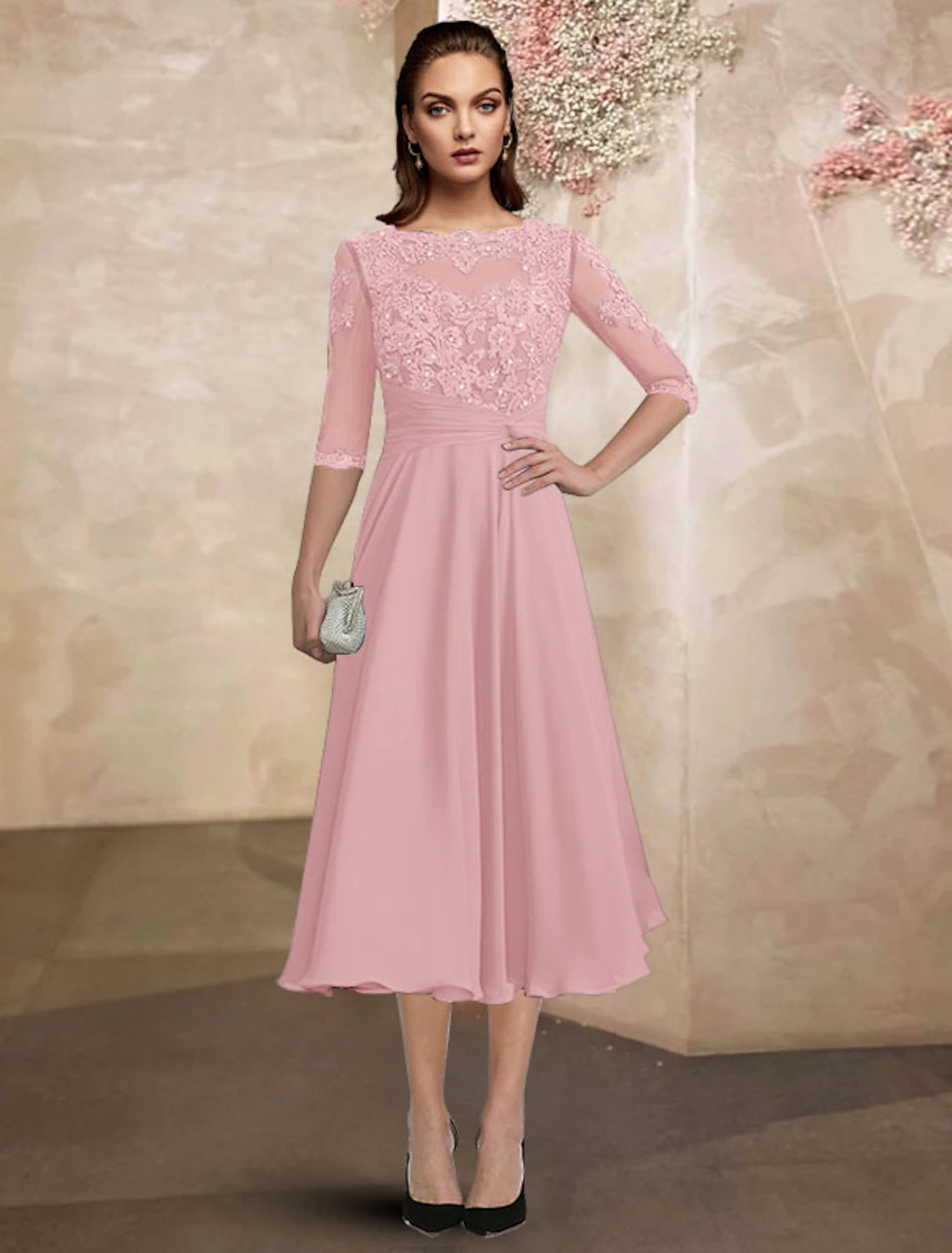 Close-up of the chiffon lace fabric and delicate beading appliques on the dress.