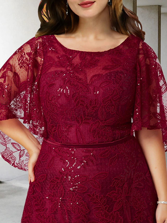 Close-up of the delicate lace and shimmering sequin appliques on the bodice and half sleeve of the gown.