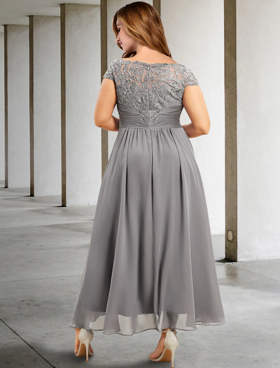 Side view of elegant plus size A-line dress with ruched bodice and appliques.