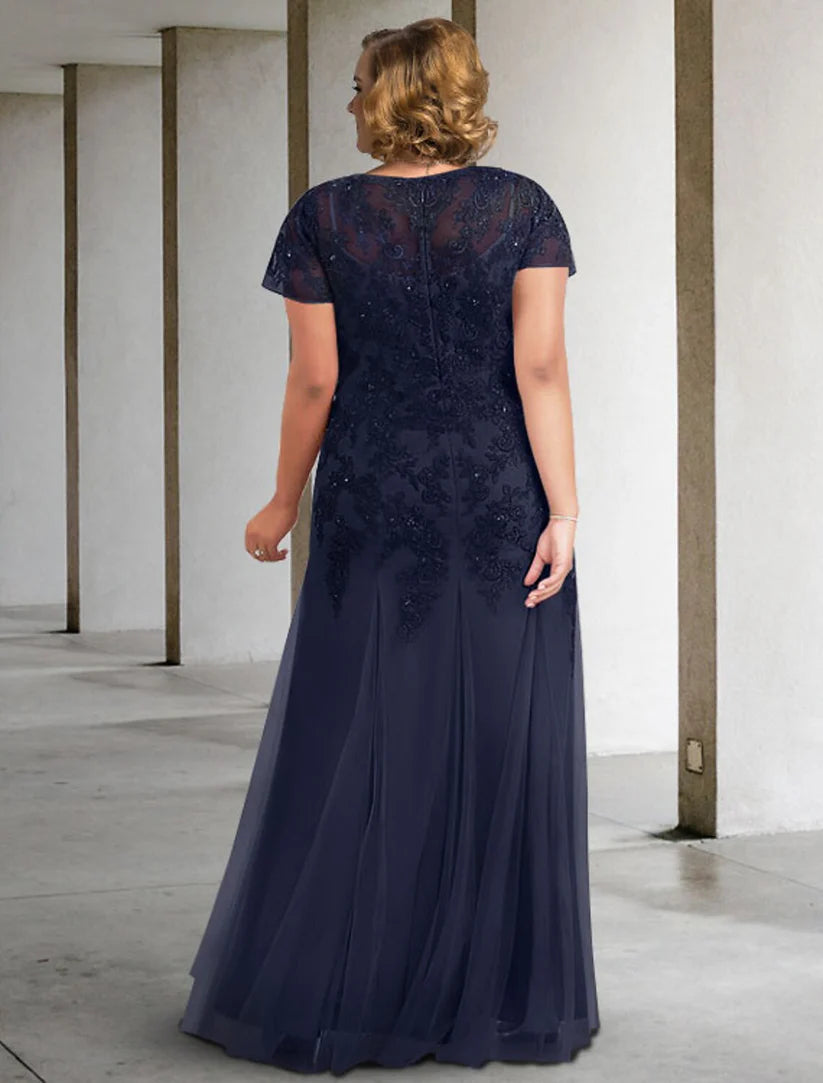Full view of the floor-length A-line dress featuring short sleeves and delicate pleats.