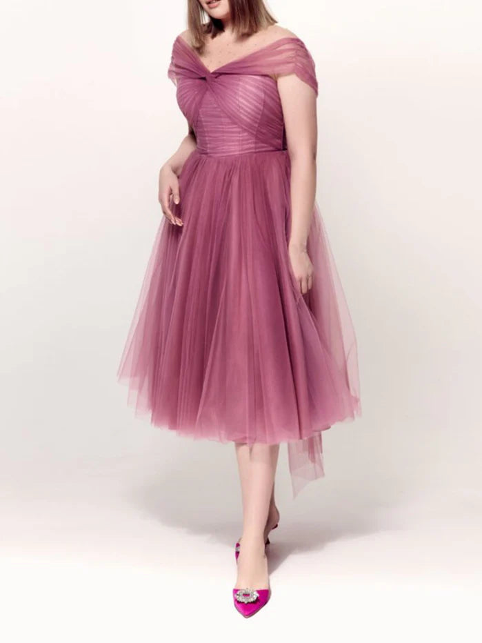 Model wearing a plus size off-the-shoulder A-line knee-length cocktail dress, front view.