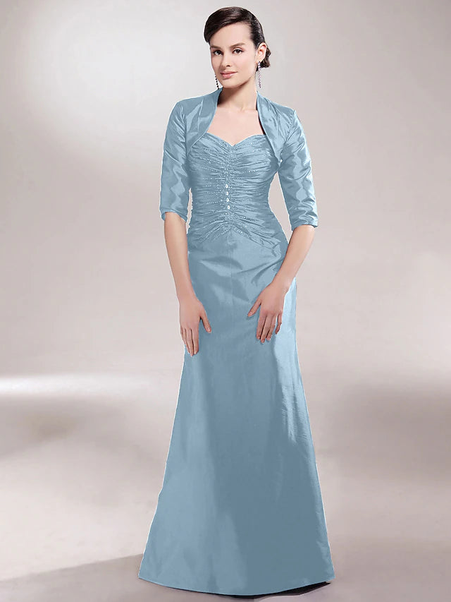 Close-up of ruched detailing and beading on the side of the dress.