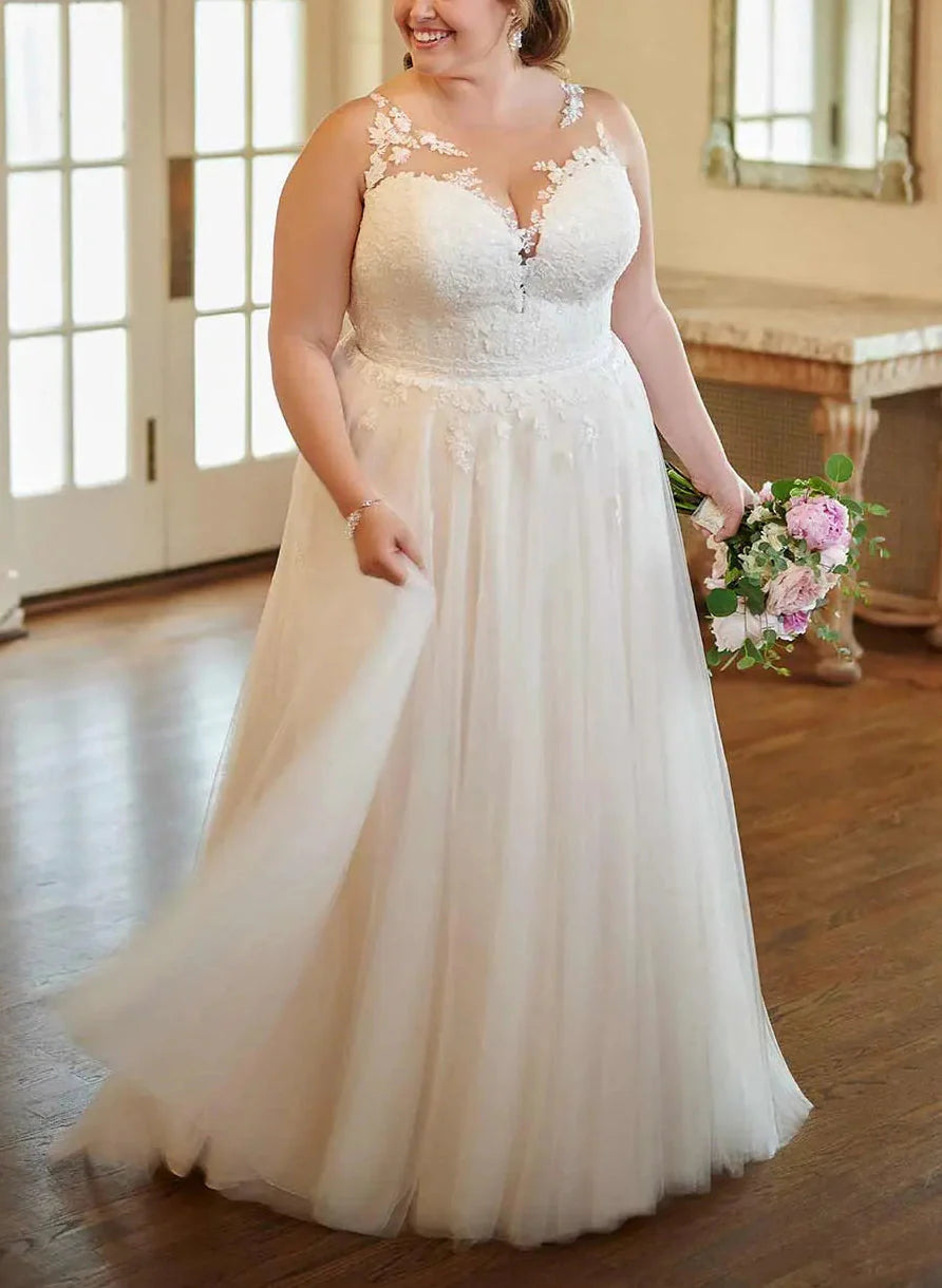 Plus size bride wearing an elegant A-line V-neck wedding dress with delicate lace appliques.