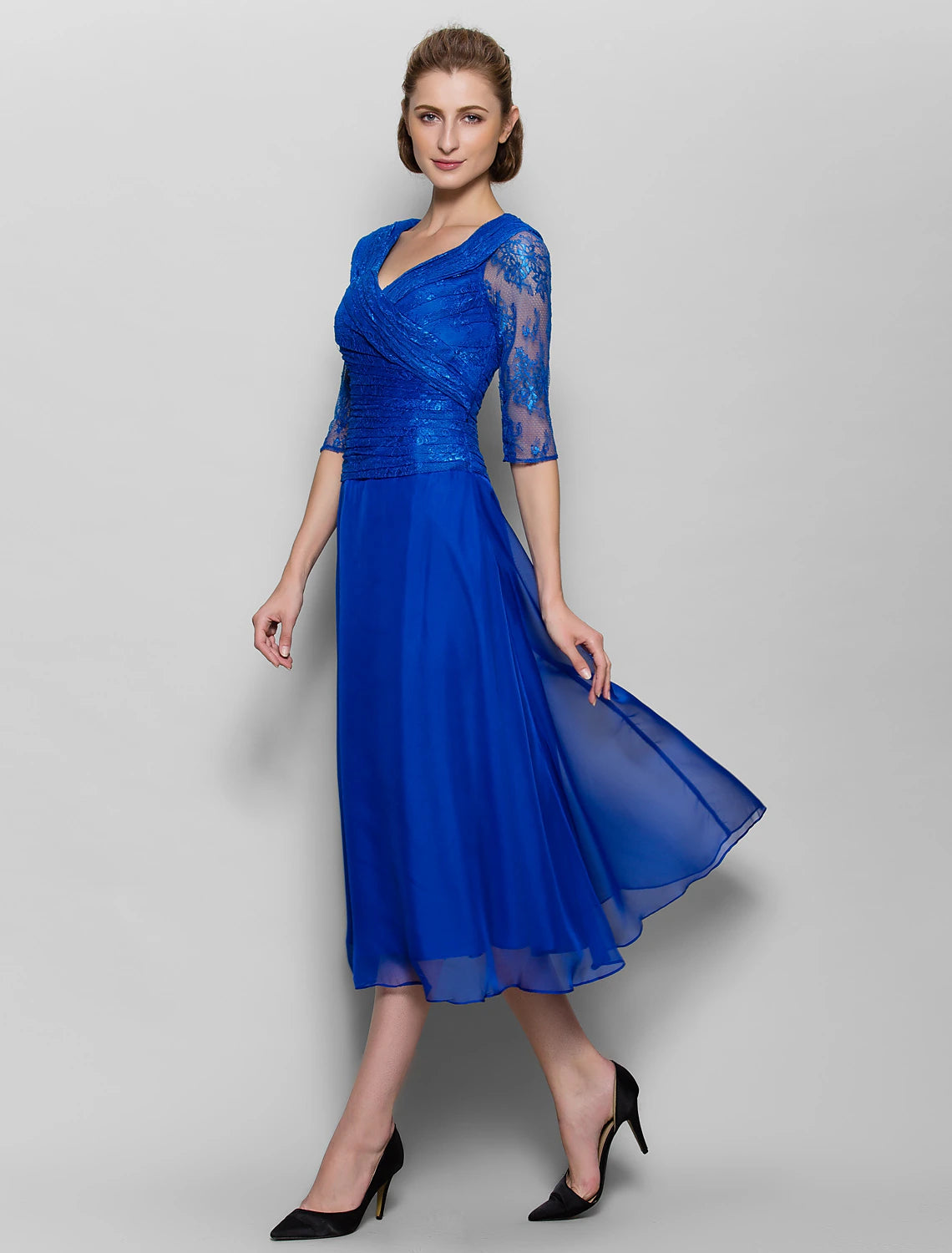 Close-up of the V-neckline and lace detailing on the plum dress.