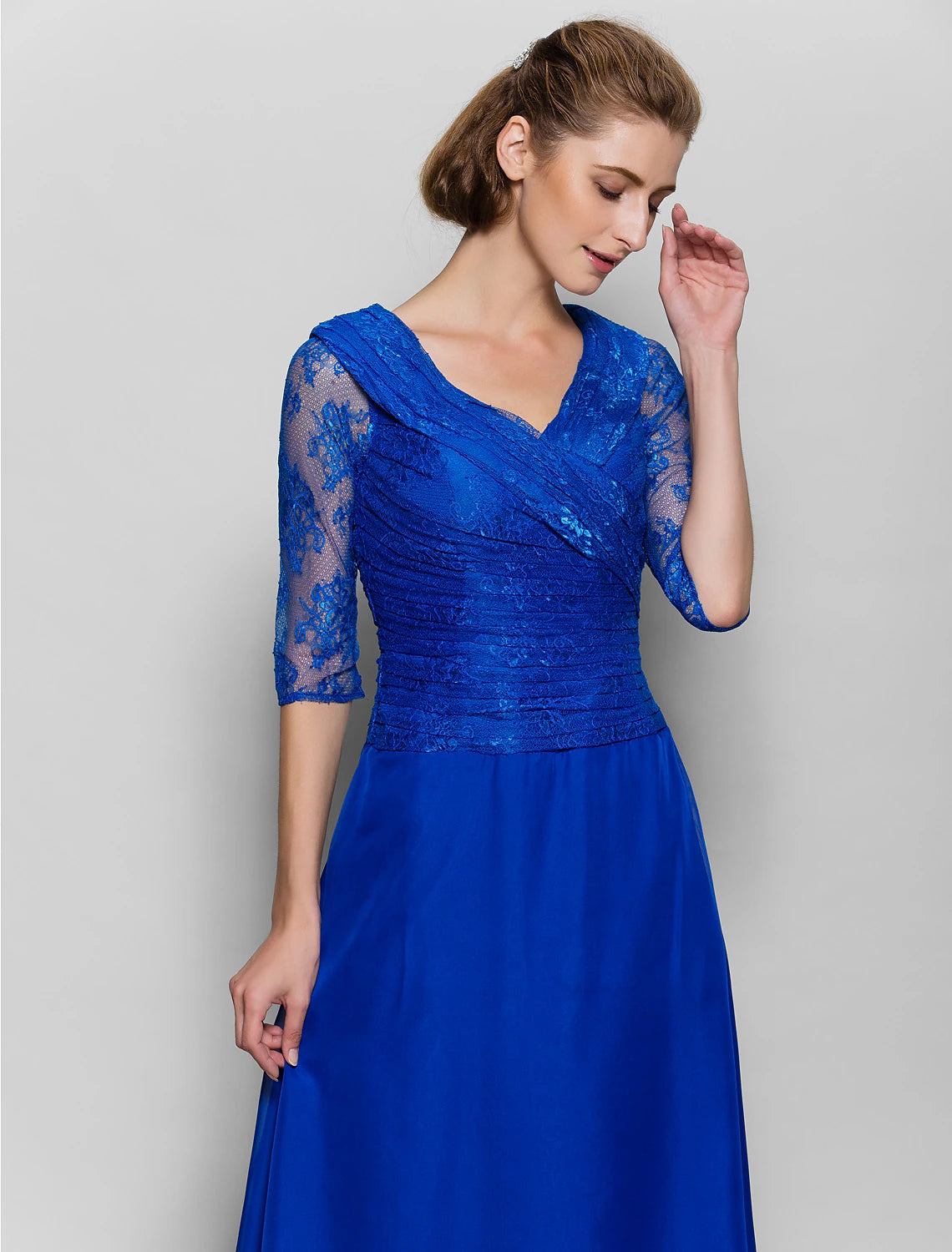 Detail of the chiffon fabric and lace embellishments on the plum dress.